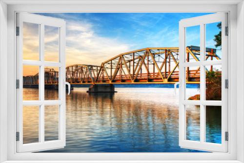 Fototapeta Naklejka Na Ścianę Okno 3D - Toll Bridge Over River At Sunrise