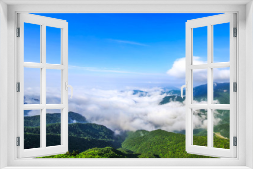 Fototapeta Naklejka Na Ścianę Okno 3D - Beautiful view above the clouds on the mountains from the aerial view