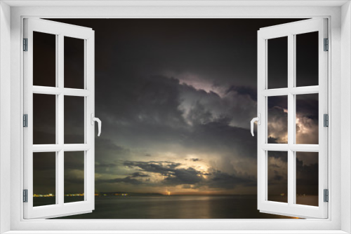 Thunderstorm over the sea, lightning beats the water