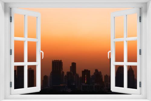 Fototapeta Naklejka Na Ścianę Okno 3D - Sunset with orange sky cityscape view.