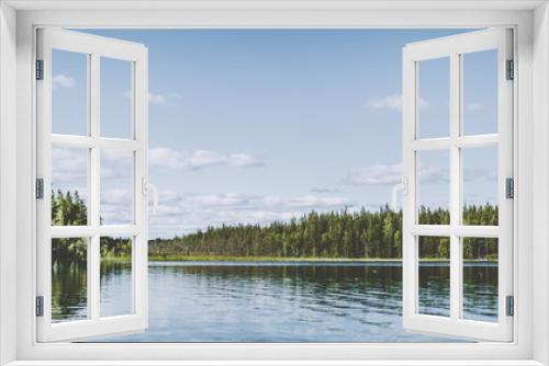 Fototapeta Naklejka Na Ścianę Okno 3D - View across a lake in the woods in Swedish Lapland