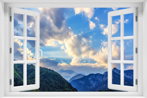 Fototapeta Naklejka Na Ścianę Okno 3D - Sunlight and clouds above the hill crowned with a wood, Austria