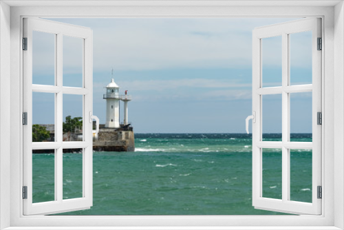 Fototapeta Naklejka Na Ścianę Okno 3D - seascape with a white lighthouse on the horizon.