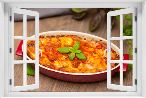 Fototapeta Naklejka Na Ścianę Okno 3D - Italian food. Hot tasty freshly baked lasagna served with basil herb on wooden table.