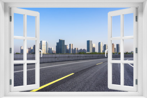 city skyline with empty asphalt road