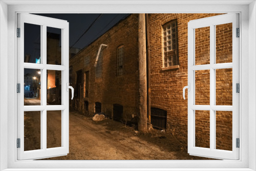 Fototapeta Naklejka Na Ścianę Okno 3D - Dark and scary urban city alley with a vintage brick a wall at night