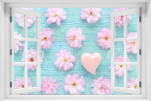 Fototapeta Naklejka Na Ścianę Okno 3D - pink cherry fresh flowers pattern with a heart on blue wooden background flat