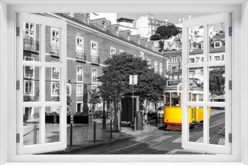 Fototapeta Naklejka Na Ścianę Okno 3D - Yellow tram on old streets of Lisbon, Alfama, Portugal, popular touristic attraction and destination. Black and white picture with a coloured tram.