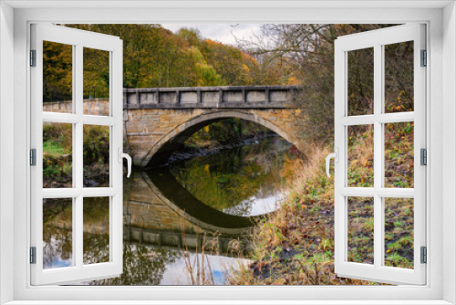 Fototapeta Naklejka Na Ścianę Okno 3D - Furnace Bridge reflected in River Blyth, located in the Bedlington Country Park, Northumberland
