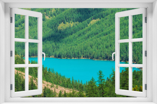 Fototapeta Naklejka Na Ścianę Okno 3D - Wonderful mountain lake in valley of highlands. Smooth clean azure water surface. Giant mountainside with rich vegetation. Amazing coniferous forest. Atmospheric green landscape of majestic nature.