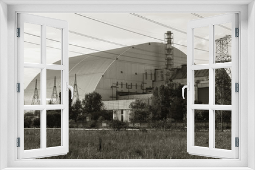 Fototapeta Naklejka Na Ścianę Okno 3D - Reactor 4 at the Chernobyl nuclear power plant with a new confinement. Global atomic disaster. Chernobyl Exclusion Zone. Pripyat in the area of ​​the sarcophagus over a blasted nuclear reactor