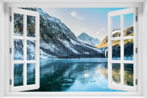 Fototapeta Naklejka Na Ścianę Okno 3D - Panoramic landscape, frozen mountain Baduk lake and mountain range with reflection on ice, national park in Caucasus mountains, Russia