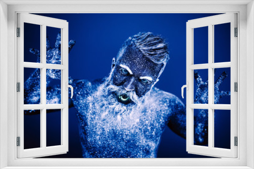 Fototapeta Naklejka Na Ścianę Okno 3D - Concept. Portrait of a bearded man. The man is painted in ultraviolet powder.