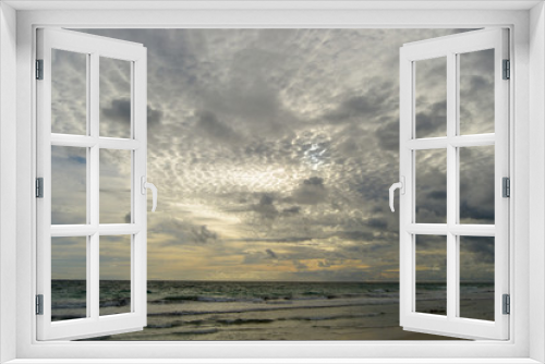 Fototapeta Naklejka Na Ścianę Okno 3D - Landscape of a beach at sunset with clouds and ocean in the horizon