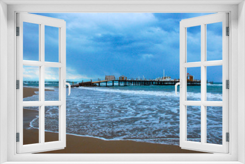 Fototapeta Naklejka Na Ścianę Okno 3D -  View from the beach to the pier during a storm