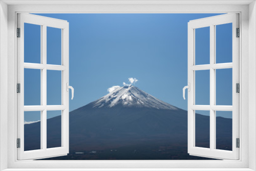 Fuji mountain in Japan with snow cover on the top with could and little fog or mist at morning