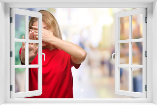 Young caucasian woman over isolated background covering eyes with hands and doing stop gesture with sad and fear expression. Embarrassed and negative concept.