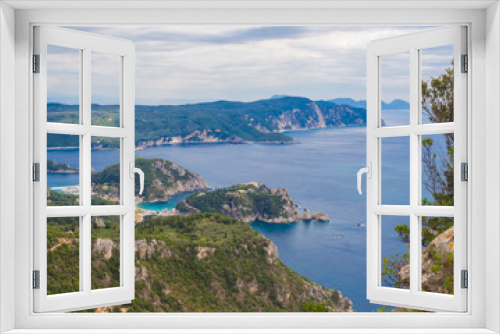 Fototapeta Naklejka Na Ścianę Okno 3D - View at zigzag road, hills cllifs, forest and turquoise blue sea at Paleokastritsa bay from the view point at mediavel castle Angelokastro, summer clody day, Corfu, Greece