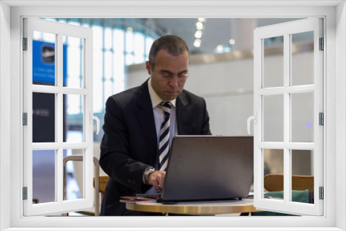 Business man working with laptop at the airport