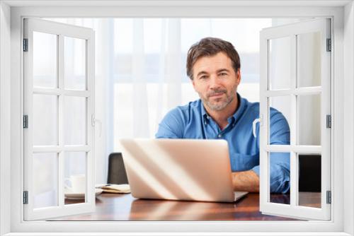 Portrait of a mature man having a little smile, on a curtains background