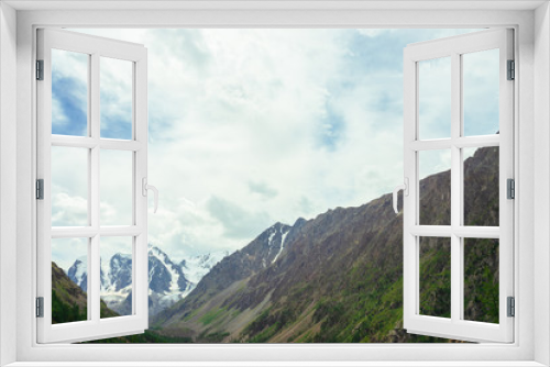 Fototapeta Naklejka Na Ścianę Okno 3D - View on wonderful glacier behind giant mountains. Snowy mountain range. Huge amazing rocky mountain with snow on top. Coniferous trees. Atmospheric landscape of majestic nature of highlands.