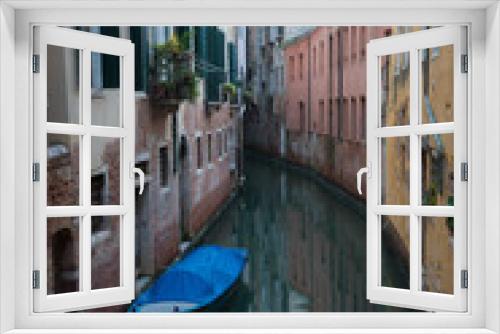 Fototapeta Naklejka Na Ścianę Okno 3D - A narrow canal between the houses in Venice