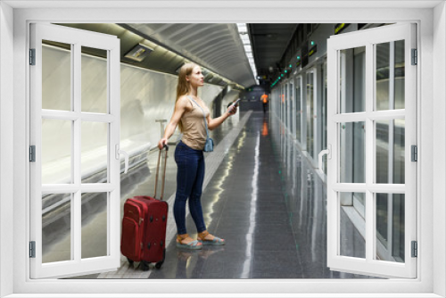 Woman on underground platform waiting train