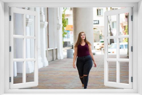 Pretty young woman walking on the city street. Casual fashion, plus size model. xxl women on nature.