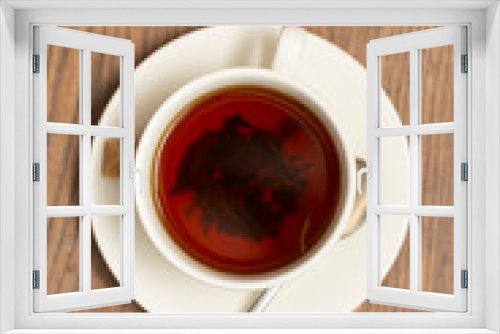 Fototapeta Naklejka Na Ścianę Okno 3D - Top view of a cup of tea on wooden table