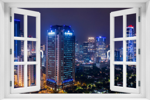 Fototapeta Naklejka Na Ścianę Okno 3D - Skyscrapers with glowing light in Jakarta downtown