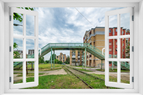 Fototapeta Naklejka Na Ścianę Okno 3D - Novi Sad, Serbia May 26, 2018: Railway line in Detelinara settlement in Novi Sad. An old overpass across the railway line.