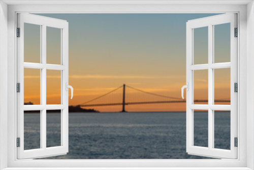 Fototapeta Naklejka Na Ścianę Okno 3D - View of the Brooklyn to Staten Island Suspention Bridge During a Winter Sunrise