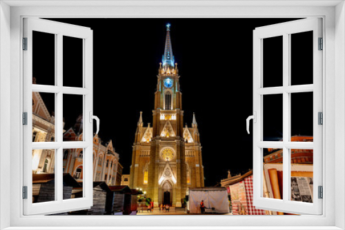 Novi Sad, Serbia May 27, 2018 : Night view of the Liberty Square (Trg. Slobode) with Mary Church, tourists and old buildings.