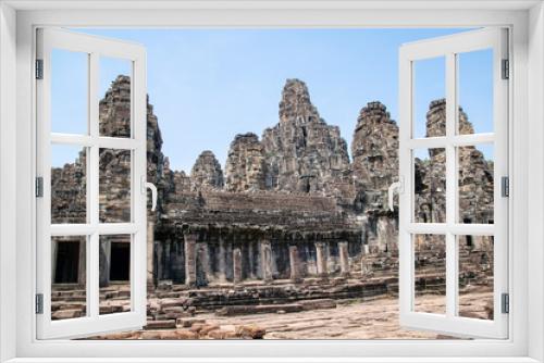 Fototapeta Naklejka Na Ścianę Okno 3D - Bayon is remarkable for the 216 serene and smiling stone faces on the many towers jutting out from the high terrace and cluster around the central peak