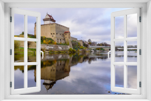 Fototapeta Naklejka Na Ścianę Okno 3D - Sightseeing of Estonia. Beautiful autumn view of Narva Castle with tall Herman's tower, Narva, Estonia
