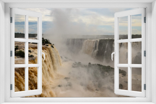 Fototapeta Naklejka Na Ścianę Okno 3D - Iguazu falls on the brazilian side with some green bushes, water mist and a cloudy sky
