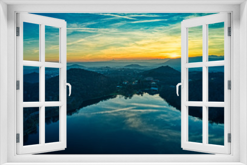 Fototapeta Naklejka Na Ścianę Okno 3D - Aerial sunset over the lake in Italy during golden hour with mountains reflections