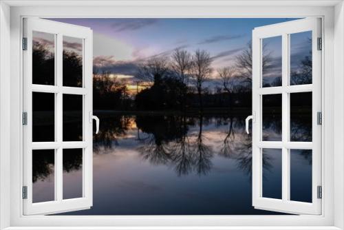 Fototapeta Naklejka Na Ścianę Okno 3D - Mirror rejections on the placid surface of a pond at sunset in Tracy City, Tennessee