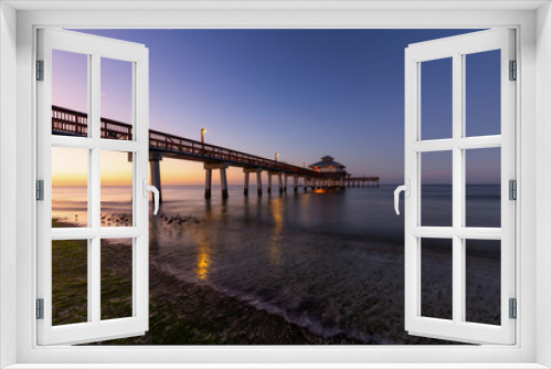 Fototapeta Naklejka Na Ścianę Okno 3D - Beautiful view of a wooden Pier on the Atlantic Ocean during a vibrant sunrise. Taken in Fort Myers Beach, Florida, United States.