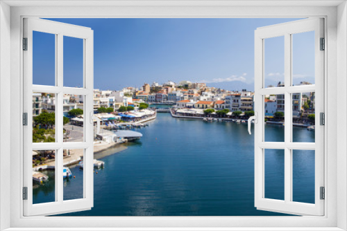 Fototapeta Naklejka Na Ścianę Okno 3D - Lake in the middle of the city of Agios Nikolaos. A beautiful small town on the island of Crete, Greece. City architecture and tourist attractions.