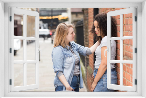 lesbian girl trying to cheer up her upset girlfriend