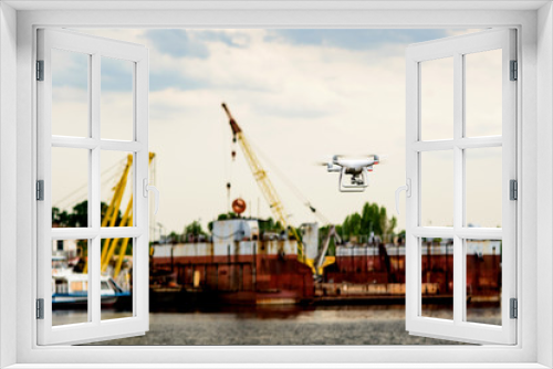 Fototapeta Naklejka Na Ścianę Okno 3D - Drone with camera flying on container cargo ship at shipping port. double exposure