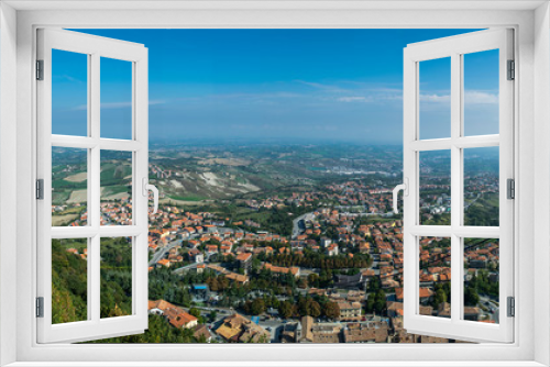 panoramic view on the hilly plain of the foothills of the Apennines with city and funicular cable way from the mountain  Monte Titano, old city of republic of san marino