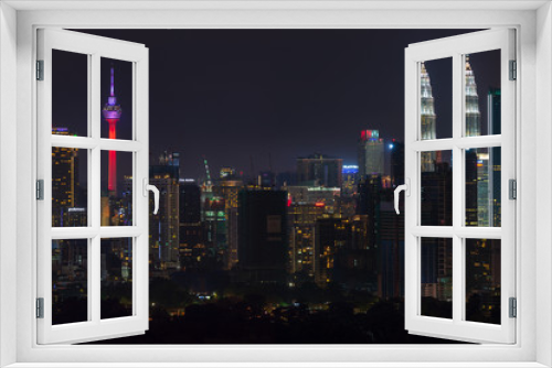 Fototapeta Naklejka Na Ścianę Okno 3D - Night view of downtown Kuala Lumpur, a capital of Malaysia. Its modern skyline is dominated by the 451m-tall Petronas Twin Towers.