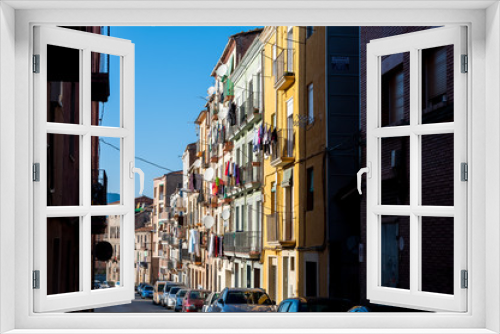 Fototapeta Naklejka Na Ścianę Okno 3D - view of street with colorful houses in small catalan spanish medieval town during sunny spring day and clear blue sky