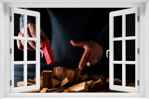 Fototapeta Naklejka Na Ścianę Okno 3D - business man try to choose wood block from others on wooden table and black background business organization startup concept