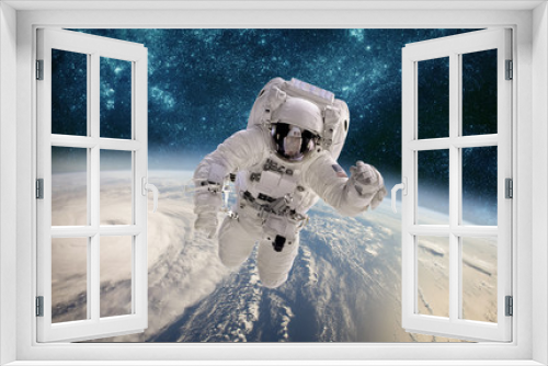 Fototapeta Naklejka Na Ścianę Okno 3D - Astronaut in outer space against the backdrop of the planet earth. Typhoon over planet Earth.
