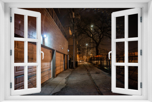 Fototapeta Naklejka Na Ścianę Okno 3D - Dark city alley with car garage doors and a scary tree at night in Chicago