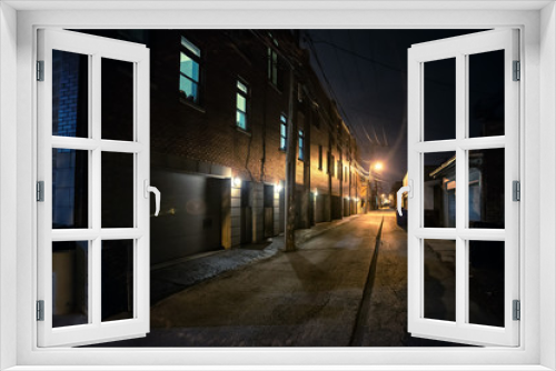 Fototapeta Naklejka Na Ścianę Okno 3D - Shadow of a person in a dark scary alley at night