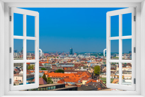 Great aerial view of Munich city with the St. Paul's Church in gothic architecture on the left and the high rise office tower Central Tower München in the centre on a nice sunny day with a blue sky.